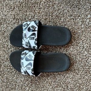 Black and white Nike slides.